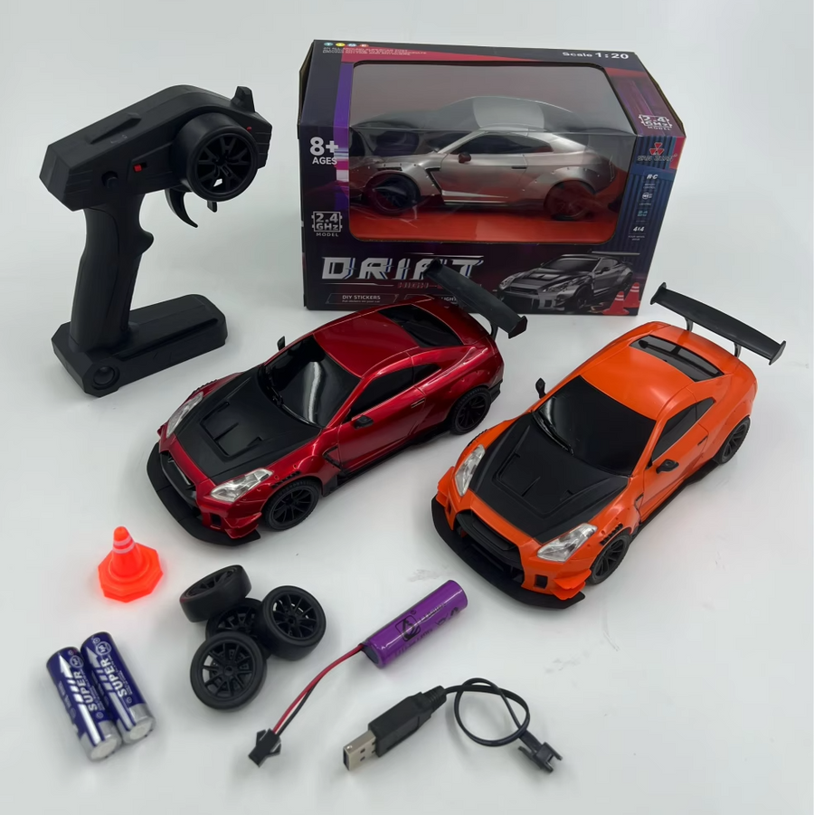 Toy car set with two cars, remote control, battery, and accessories on a white background